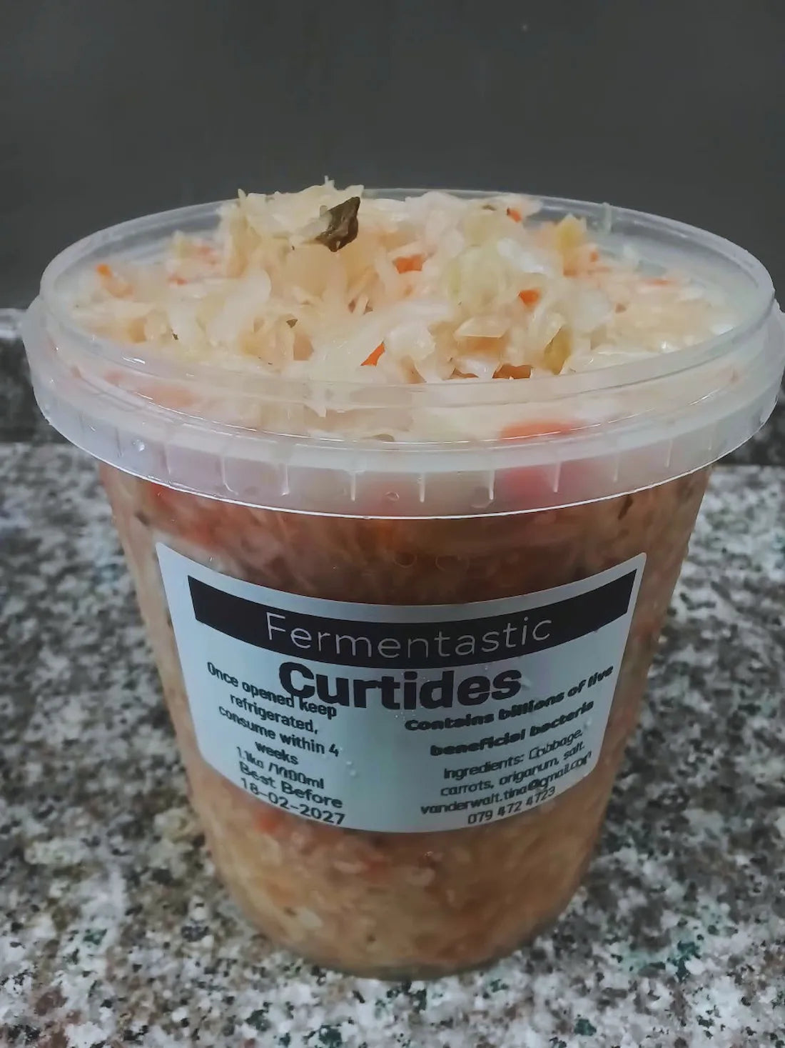 Fresh curtido fermented slaw served in a small tub