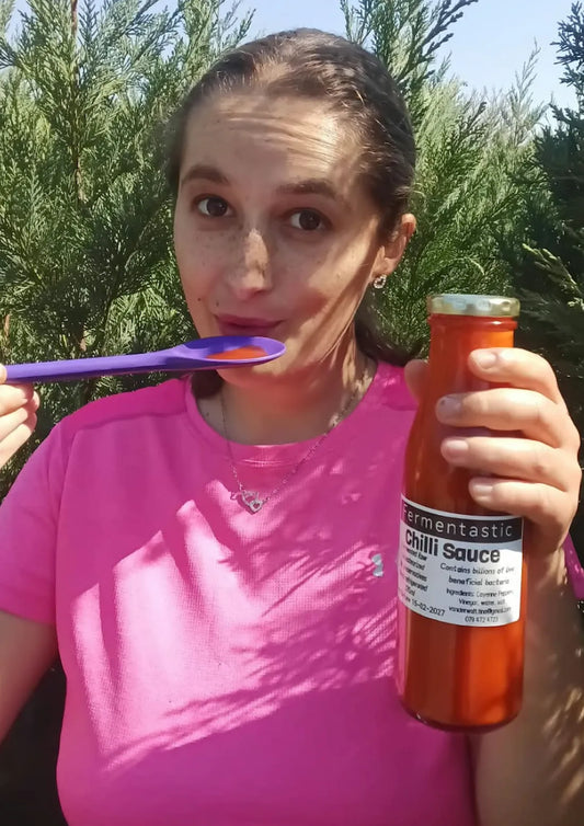 Kristi tasting Fermentastic Raw Fermented Chilli Sauce for the first time — mild, tangy and alive with live cultures