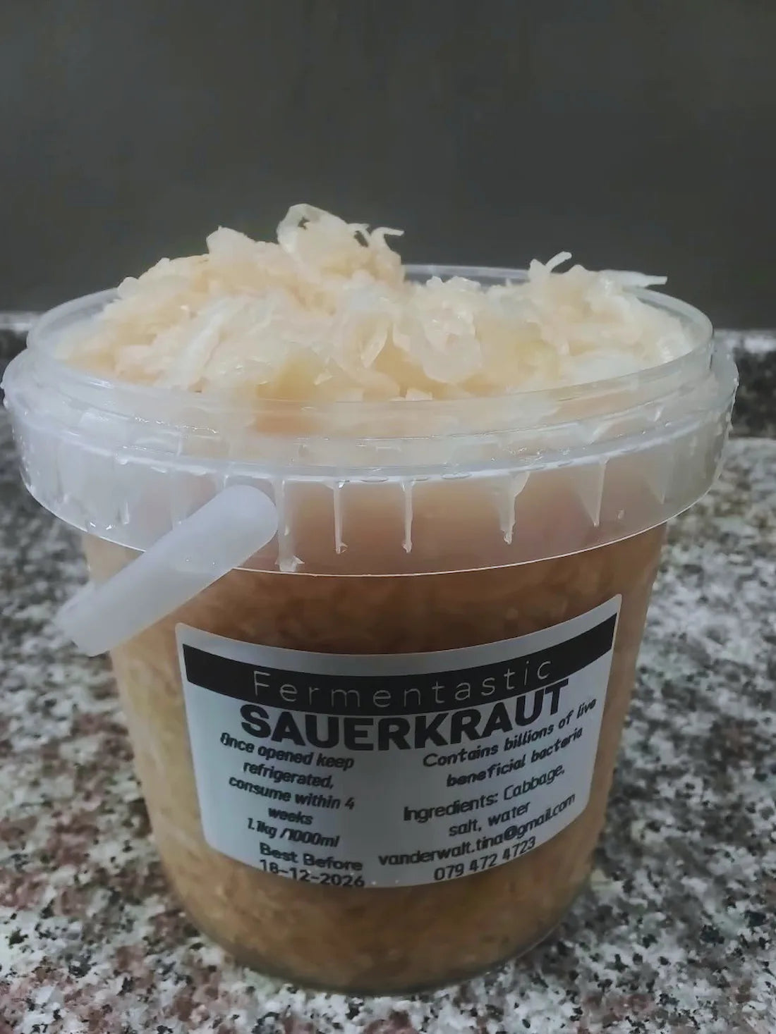 Fresh raw sauerkraut served in a small tub